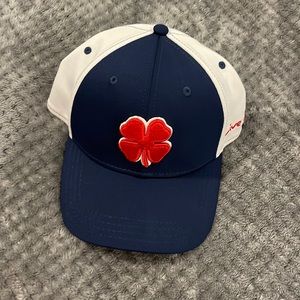 Red, white & blue Black Clover golf hat.